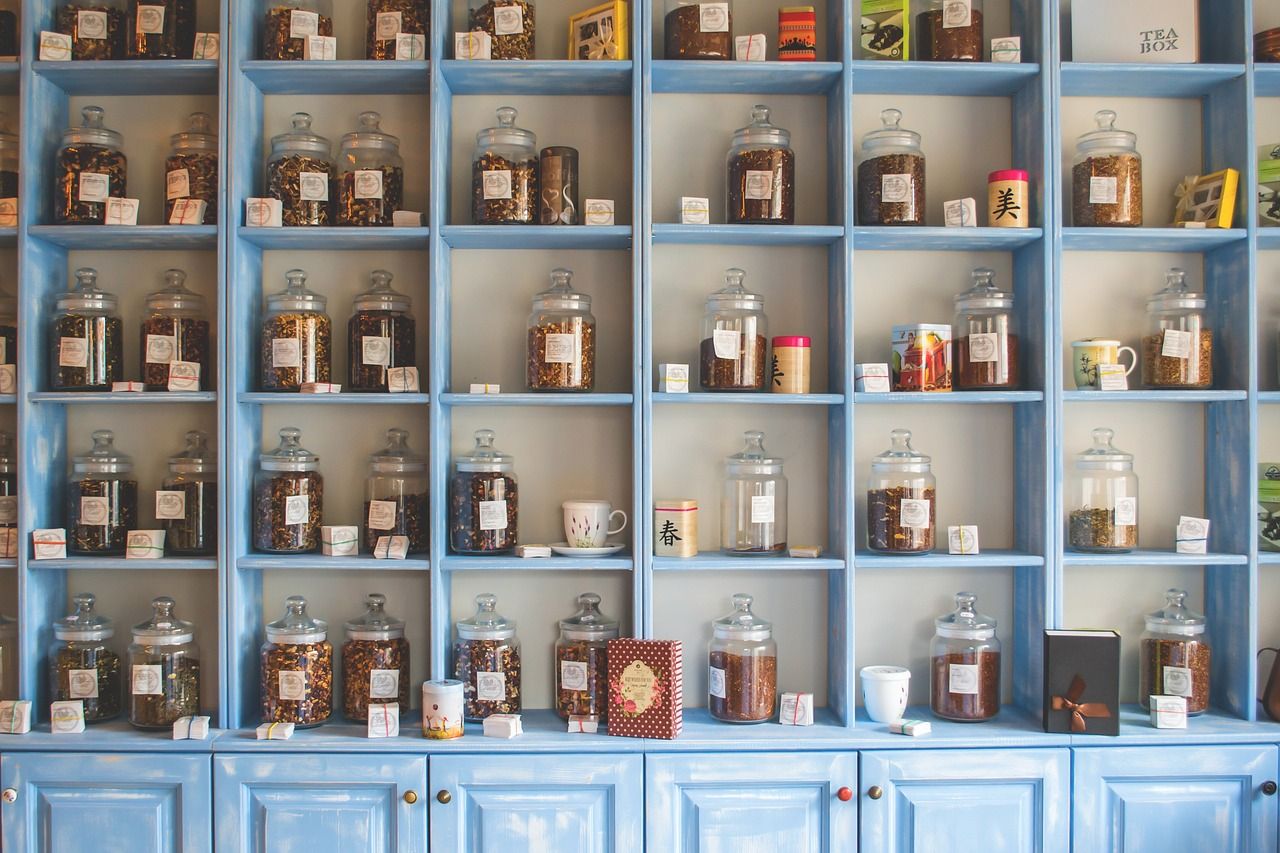 Glass jars of loose-leaf tea on the shelves of a Chinese tea shop — tea is still the entry point of the China Haul shopping list