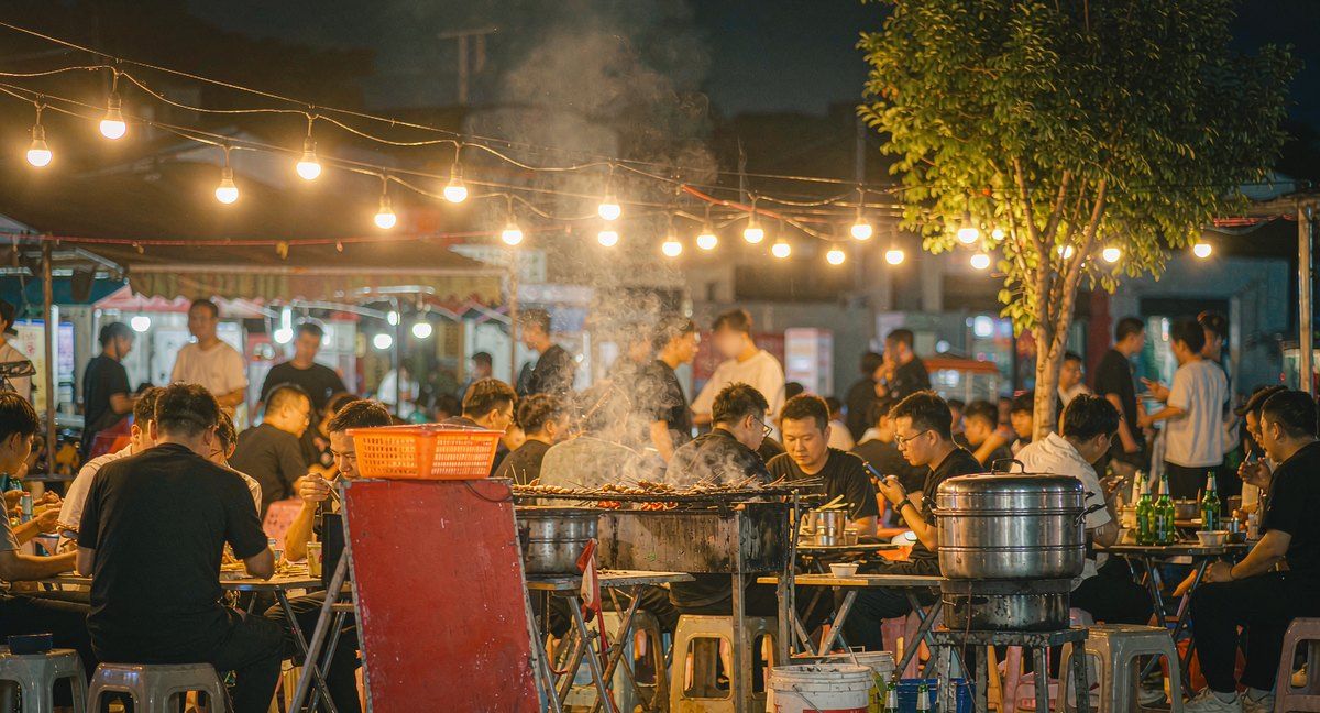 Barbecue skewer stalls under strings of warm bulbs at an evening night market in a northern Chinese city — AI-generated illustration, not a photograph of the actual market