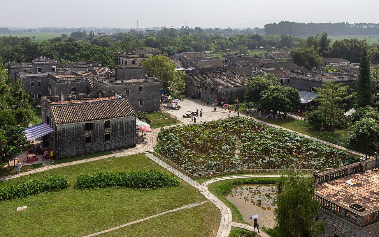 Village roofs, lanes and a lotus pond inside Zili village — the walk between towers