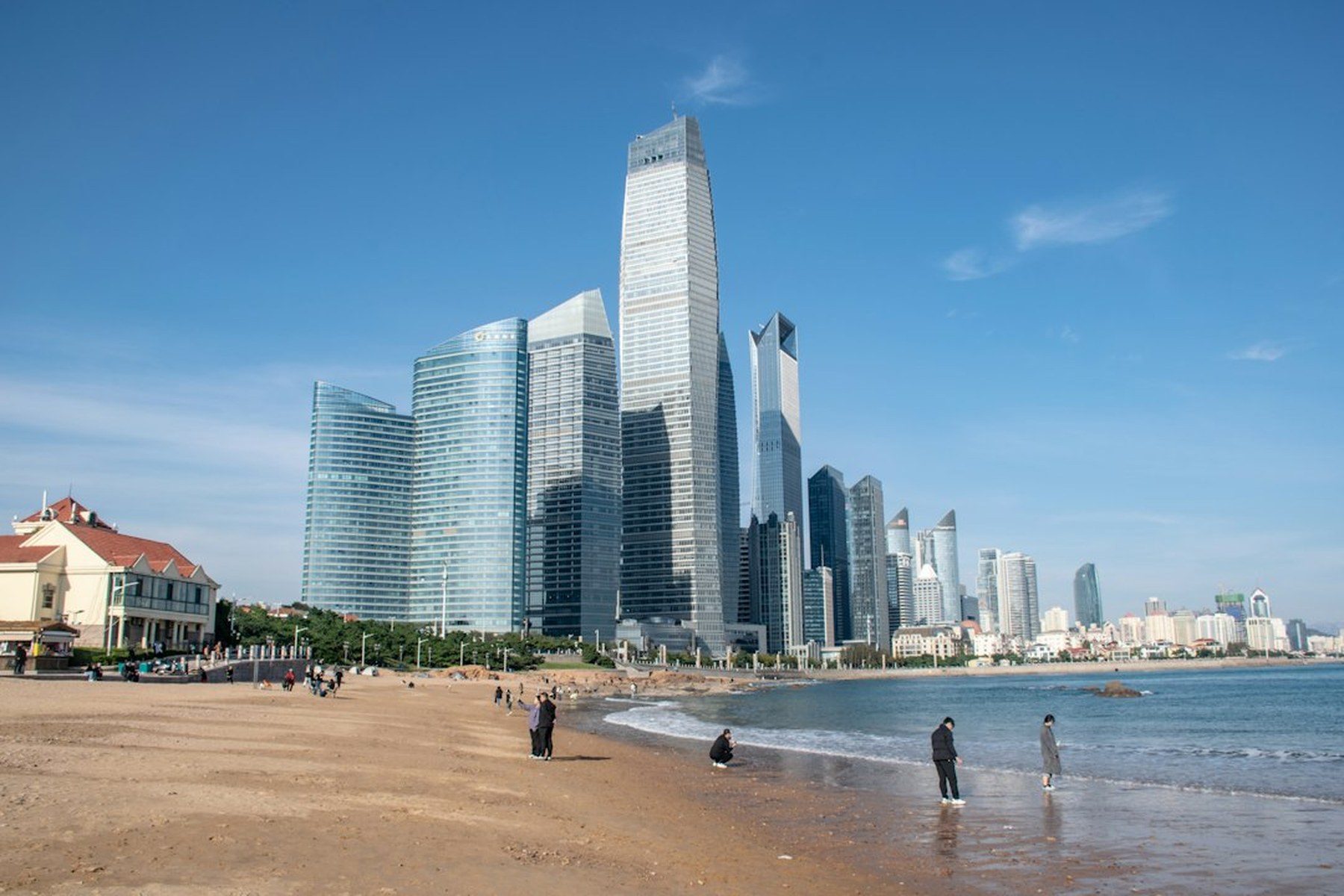 Qingdao's beachfront with modern skyscrapers behind it — the coast that Metro Line 8 now reaches from the airport in about 40 minutes