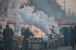 Steam pouring from food stalls at a dawn street market in northern China — AI-generated illustration, not a photograph of the actual market